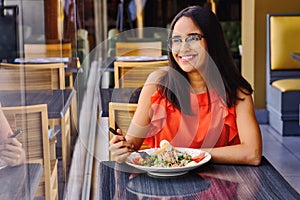 Latinamerican girl have a lunch in restaurant