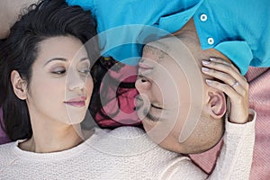 Latino Couple Laying Down