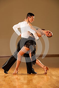 Latino dance couple in action - dancing wild samba