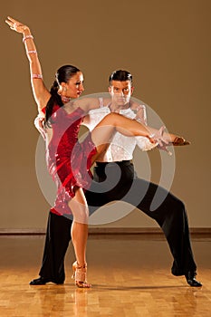 Latino dance couple in action - dancing wild samba