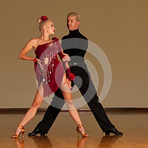 Latino dance couple in action preforming a exhibition dance - w