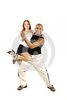 Latino dance instructor carrying girl