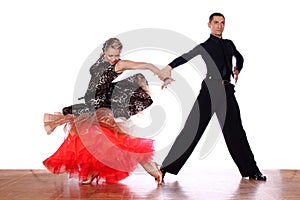 Latino dancers in ballroom against white background