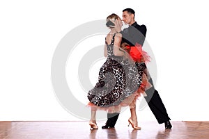 Latino dancers in ballroom against white background