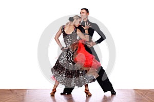 Latino dancers in ballroom against white background