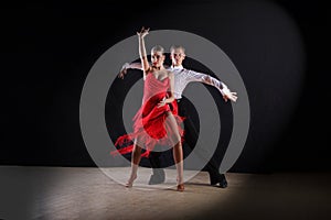 Latino dancers in ballroom isolated on black