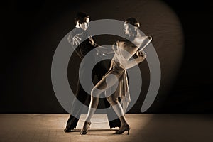 Latino dancers in ballroom isolated on black