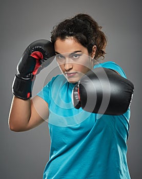 Latino female fighter delivering a jab