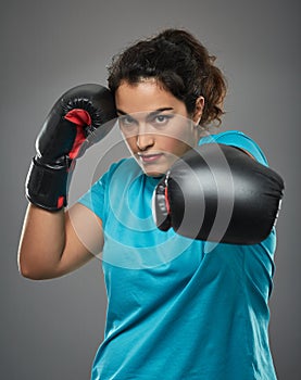 Latino female fighter delivering a jab photo