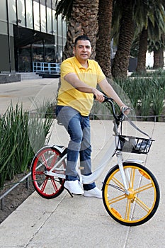 Latino men 40 years old use bicycles city transportation system tickets to avoid vehicle traffic and not contaminate them