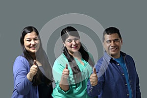 Latino women and a man show their thumb inked with indelible electoral ink after voting in the election photo