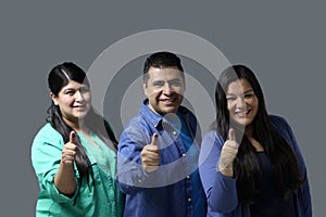 Latino women and a man show their thumb inked with indelible electoral ink after voting in the election photo