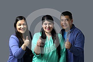 Latino women and a man show their thumb inked with indelible electoral ink after voting in the election photo