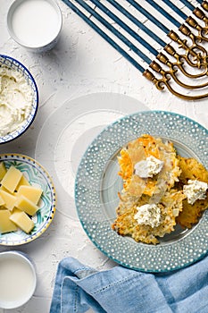 Latkes, cheese, milk and curd cheese, Hanukkah on white table free space