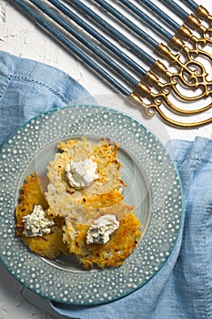 Latkes and curd cheese on a plate, Hanukkah close-up