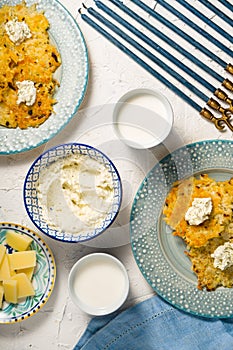 Latkes, milk and cheese cheese, Hanukkah on a white table