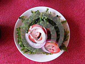 Lato salad or seaweed salad with fresh Philippine seaweeds, sliced raw red tomatoes and sliced raw red onion photo