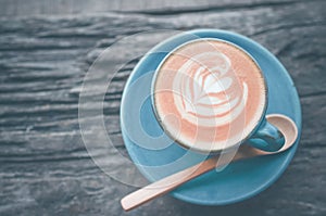 Latte art, Blue coffee cup on wooden background