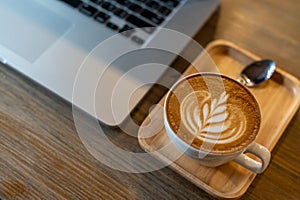 Latte art coffee cup with laptop