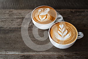 Latte art coffee with swan and heart tree shape in coffee cup