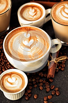 Latte art drawn on various espressos photo