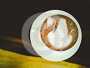 Latte art, swan pattern on hot coffee in white glass