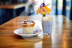 latte with blueberry muffin on a caf table