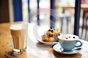 latte with blueberry muffin on a caf table photo