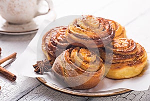 Latte or cacao and Cinnamon Bun for breakfast or break on white background. Cup of coffee and homemade buns