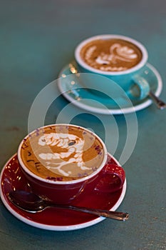 Latte coffee with latte art in a coffee cup with tea spoon