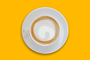 latte coffee in a ceramic coffee cup isolated on bright yellow background top view