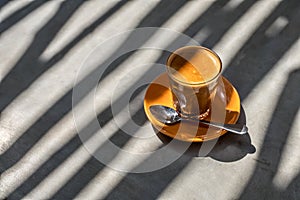 Latte drink in glass on saucer