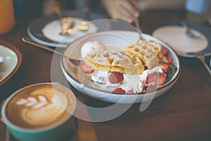 Latte hot coffee with many desert of waffle and chocolate cake