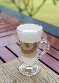 Latte macchiato in a glass with milk froth