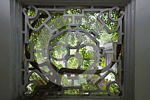 Lattice window or ornamental window at Humble Administrator`s Garden or Zhuozheng yuan in Suzhou,