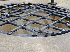 Latticed water well iron cover