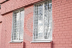 Lattices on windows of red brick building