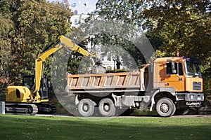 Latvia. Excavator loads trash