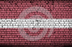 Latvia flag is painted onto an old brick wall