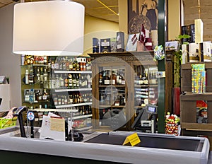 Interior of wine counter with vintage style wooden showcase and cash desk.