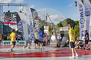 Urban basketball players playing basketball on sports court in Riga