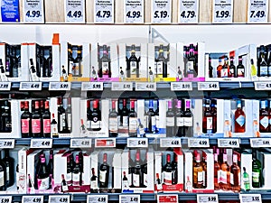 Various wines in sales boxes with promotional discounts on the shelves of the Lidl supermarket, Riga.