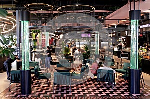 Modern of Burzma food court interior with interesting lamps and with varied lighting in Gallery Center shopping mall, Riga