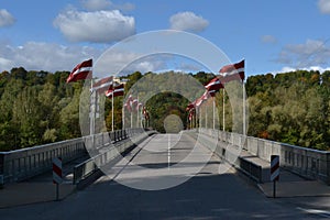 Latvia, sigulda. Decorated bridge with Latvian flags on a national holiday