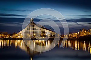 Latvian national library and stone bridge over Daugava river in Riga.