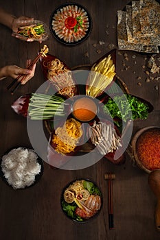 Lau. Hot pot with pork, banana flowers, mango, salted fish, scrambled eggs, rice noodles