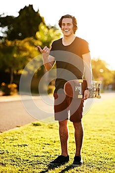 Laugh, portrait and skateboarder with shaka hand gesture outdoor for hobby, skill practice and cruising. Male person