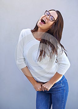 Laugh, smile and happy woman for fashion, style and clothing range isolated on gray background. Female person, lady and