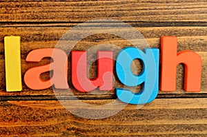 Laugh word on table