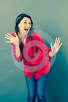 Laughing 30s woman expressing herself with dynamic hand gesture